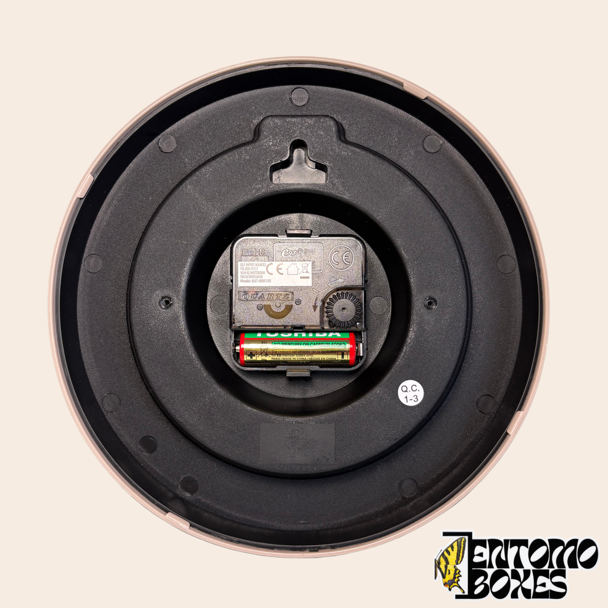Parte trasera del reloj con mecanismo de cuarzo, ranura para colgar y hueco para una pila AA (pila no incluida)