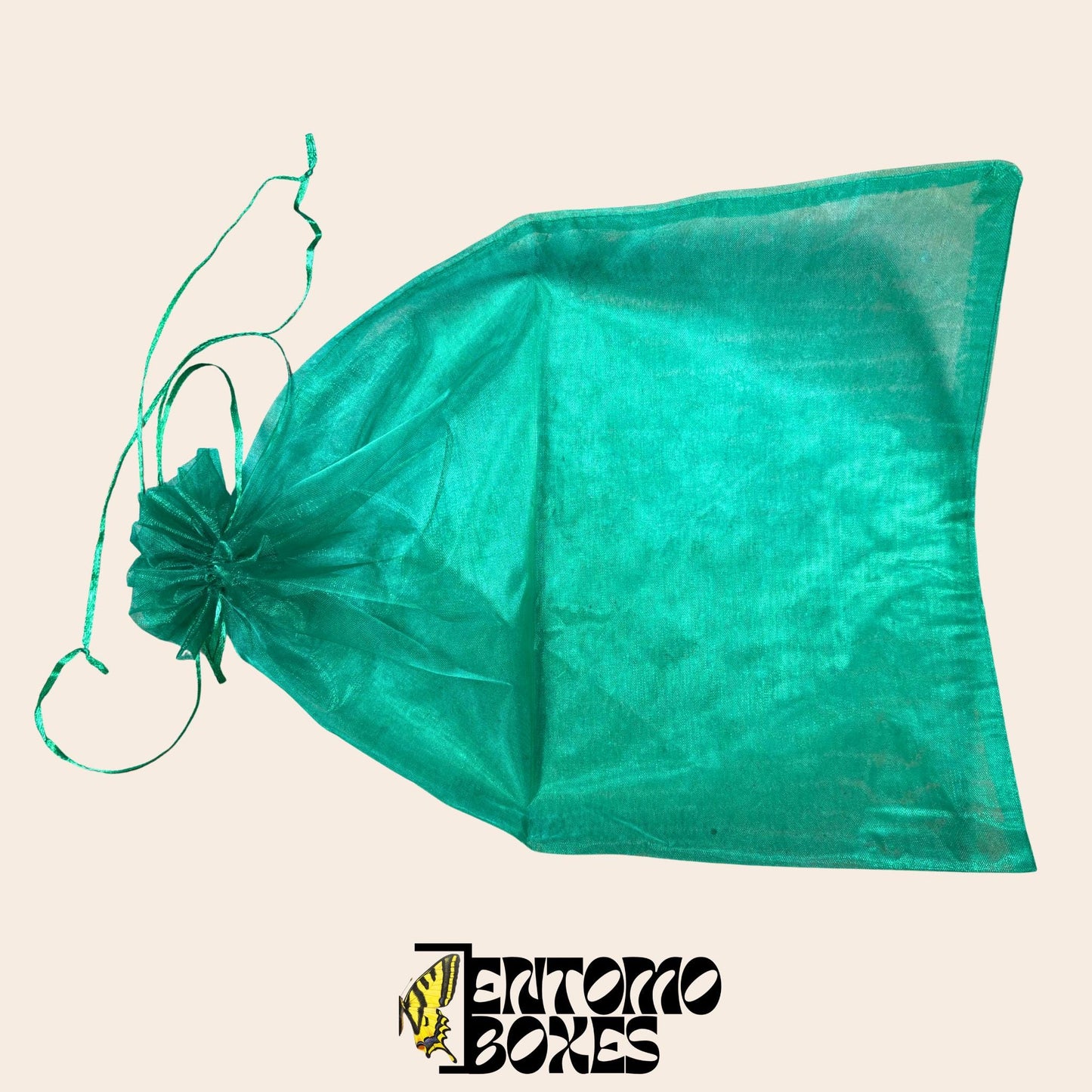 Folded green mesh breeding bag with drawstring on a beige background, alternate angle.