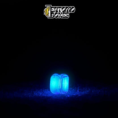 EntomoBoxes moth light trap as the only light source glowing blue in a dark field at night